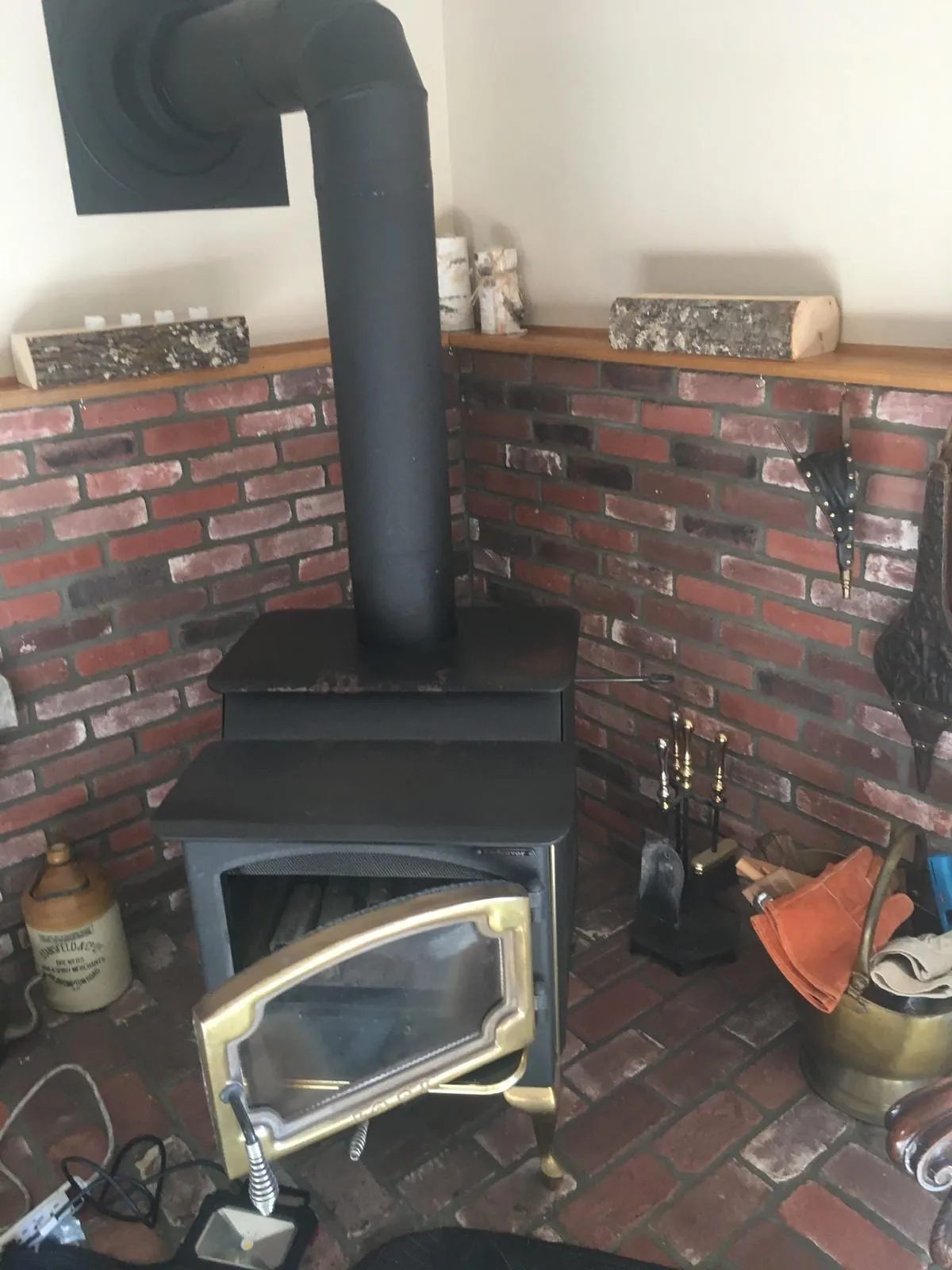 A wood-burning stove set into a brick surround in a New Jersey living room