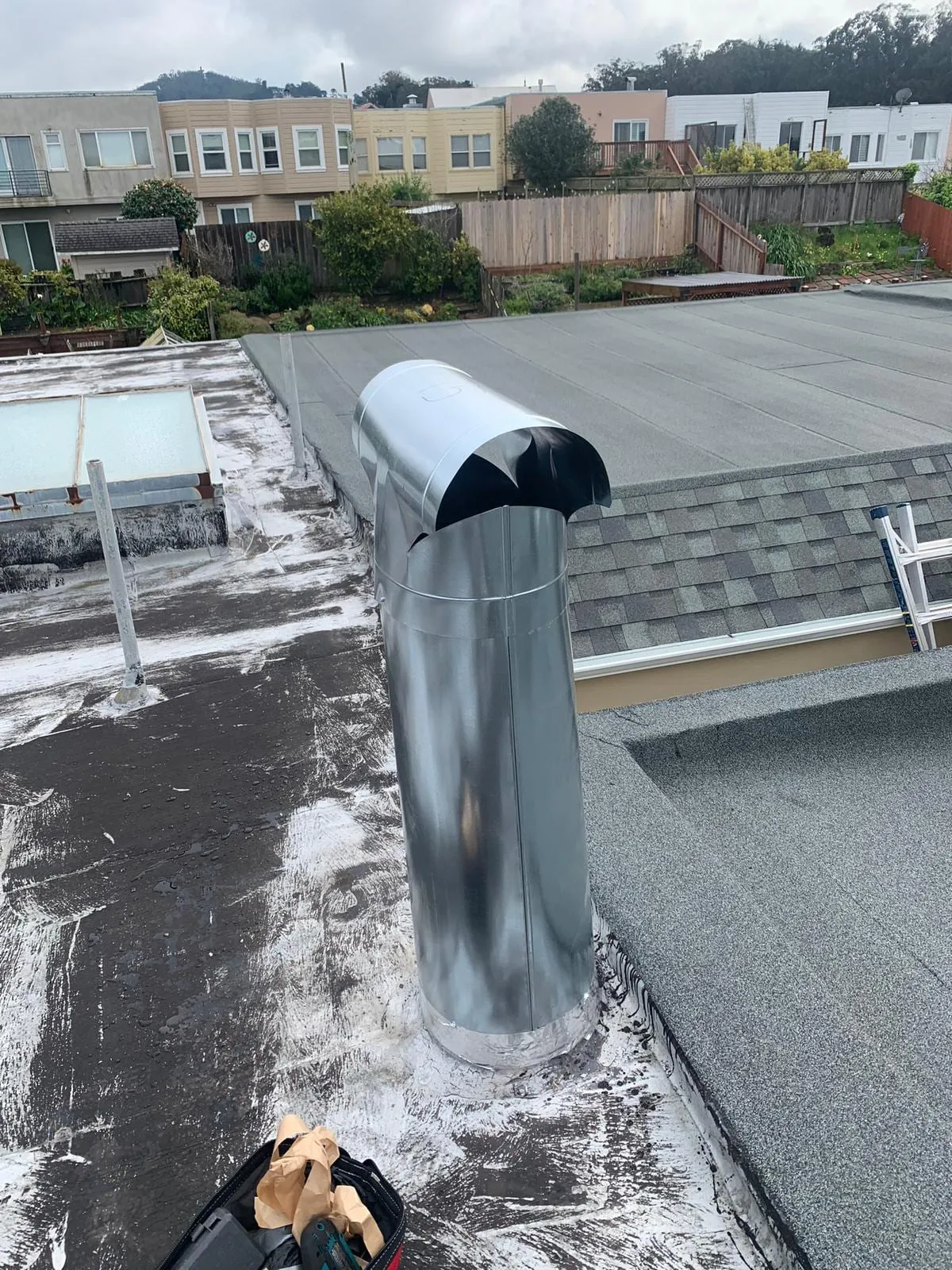 A metal flue terminal on an urban flat roof, the part a Level 2 scan reaches