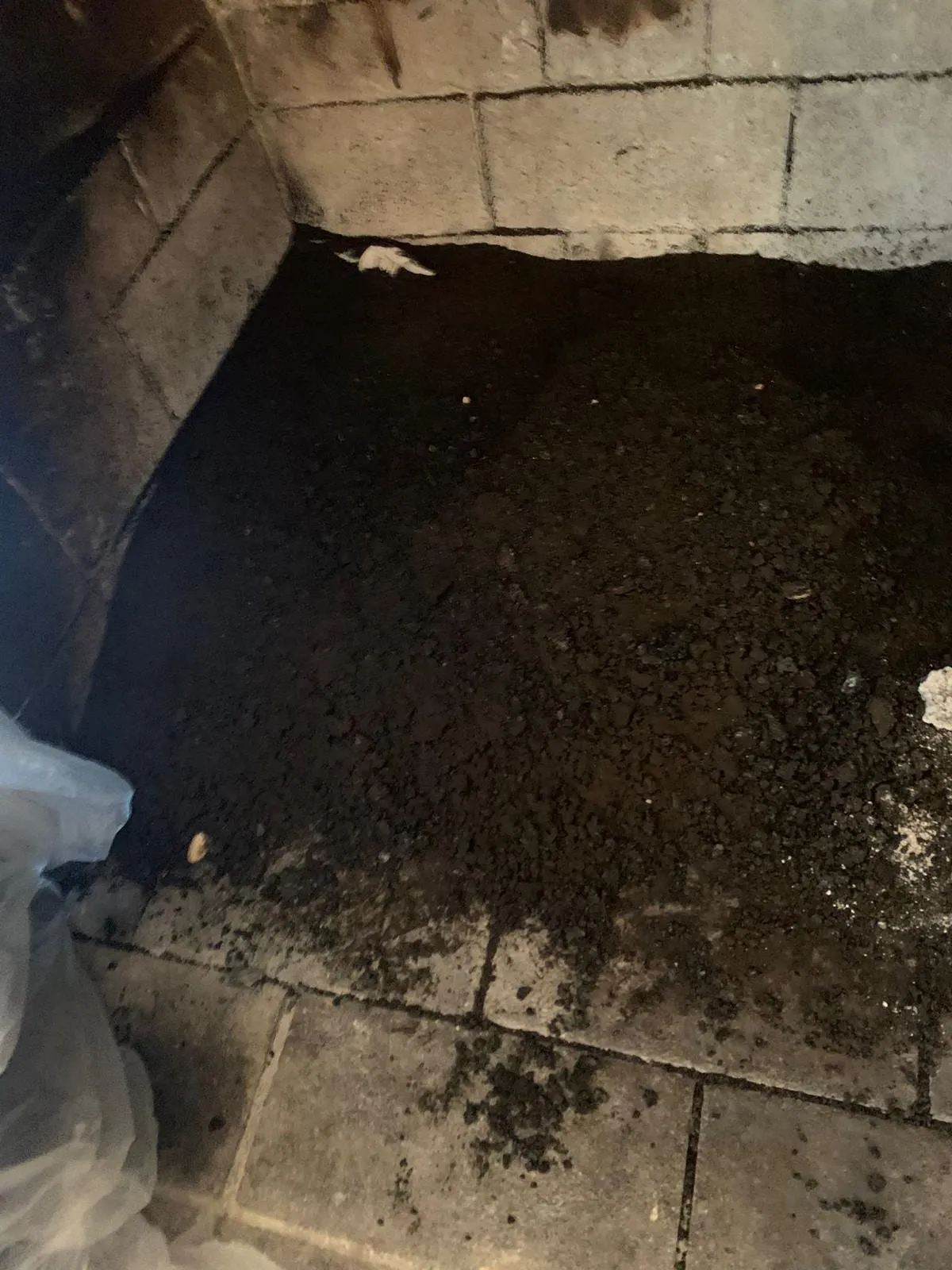 The inside of a soot-caked firebox before cleaning, in a North Jersey home