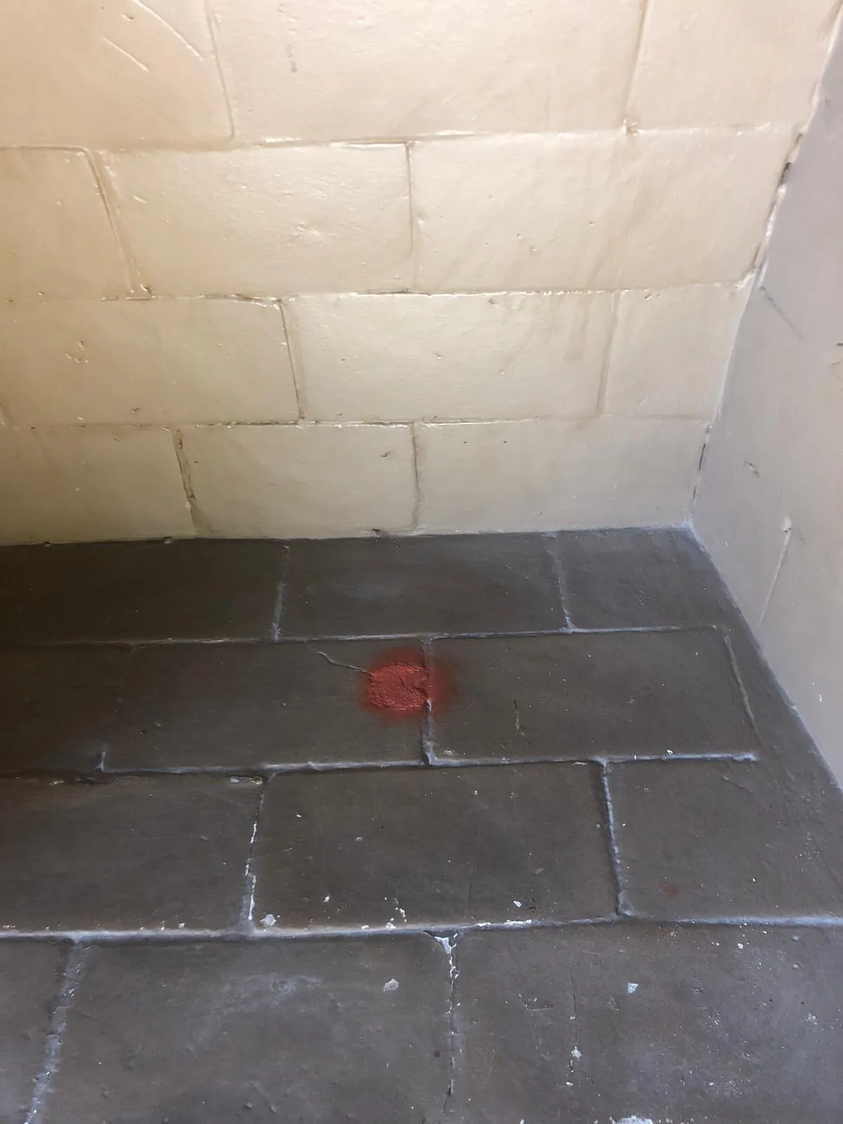 A swept firebox, the block wall and tiled floor visible again