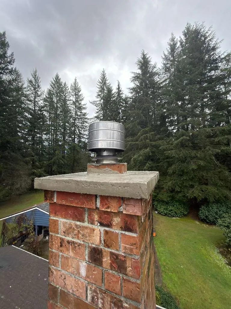 A brick chimney fitted with a new stainless cap